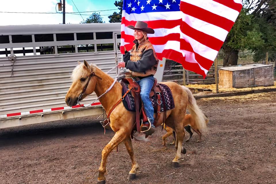 on horseback with the American Flag